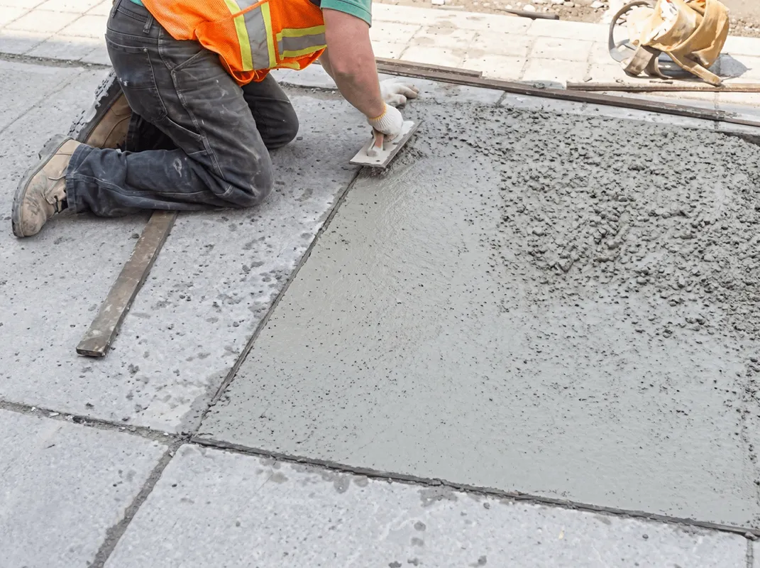Professional repairing a concrete floor in Pittsburgh, PA